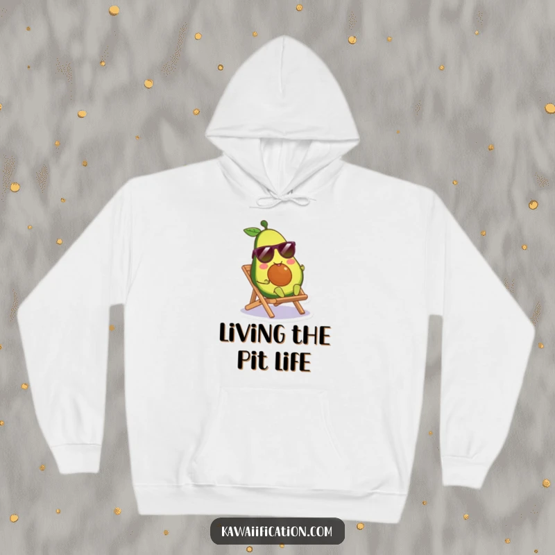 Funny avocado character wearing sunglasses, lounging on a tiny beach chair, featured on a soft and warm hoodie.