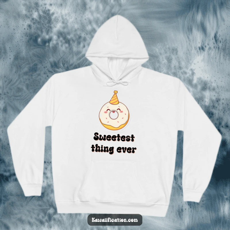 Funny hoodie showcasing a delighted donut character attempting to wear a tiny party hat, perfect for cozy and festive occasions.