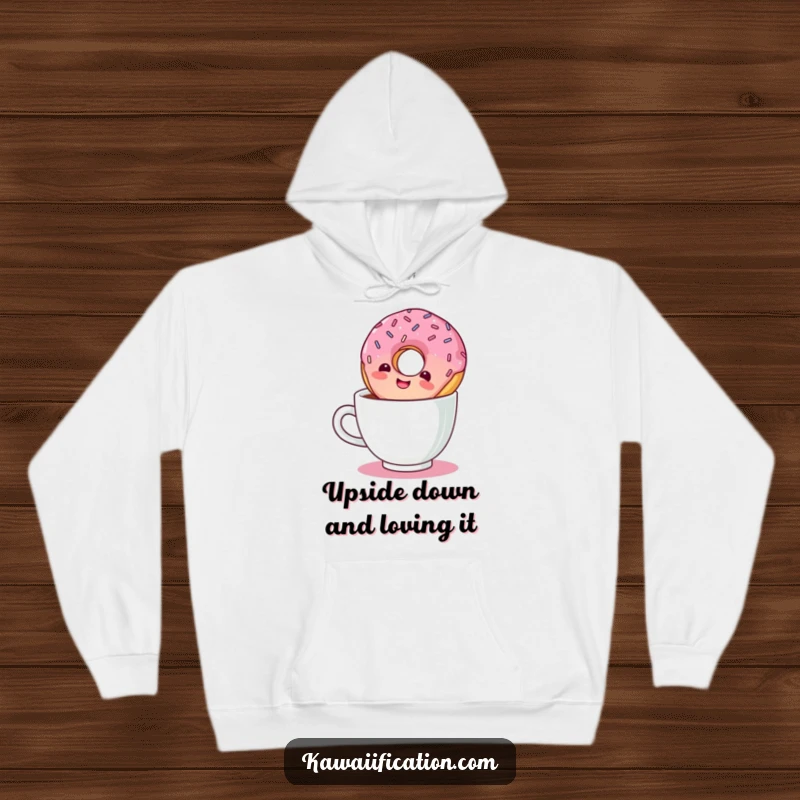 Funny hoodie design showing a giggling donut with sprinkles taking an inverted plunge into a coffee cup.